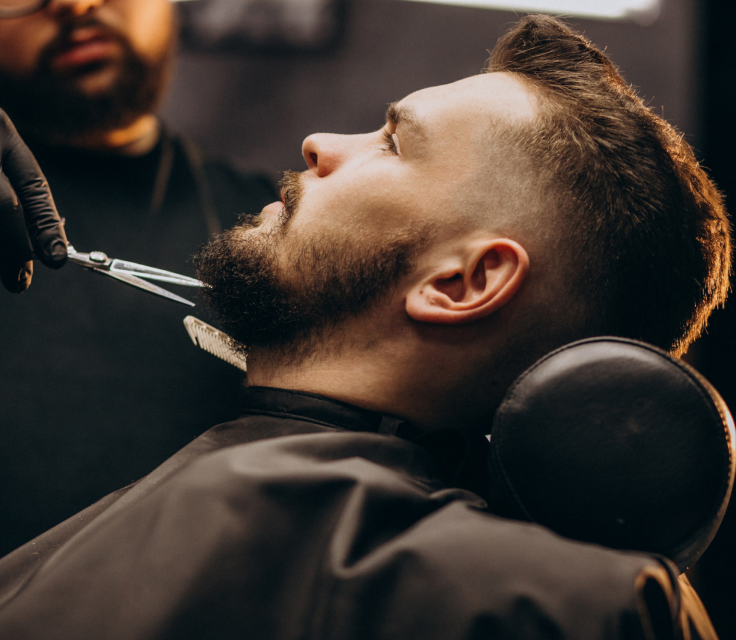 Barber shaping a beard